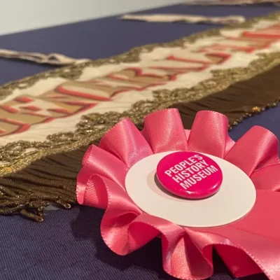 promotional image of a rosette and election poster advertising General Election Trail at People's History Museum Manchester