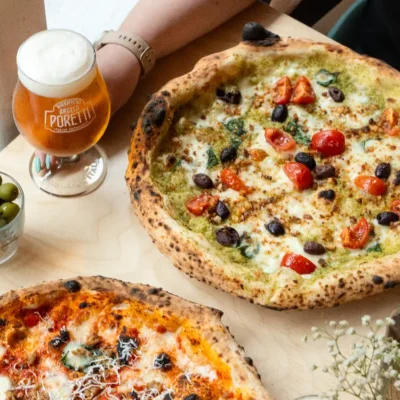 promotional image of a pizza and beer for Rudys Pizzeria Altrincham