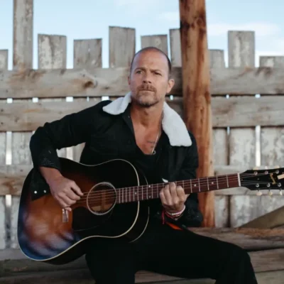 image of Kip Moore playing guitar. promotional image courtesy PJ Brown