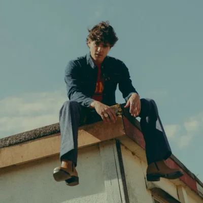 image of Bradley Simpson sat on a rooftop