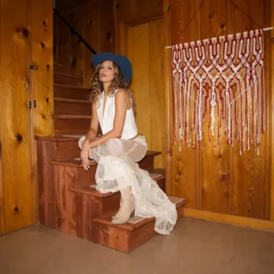 promotional image of Twinnie sat on stairs