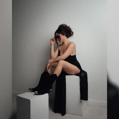 promotional image of Taylor Rae sat on blocks for new single Cologne. image courtesy Barbara FG
