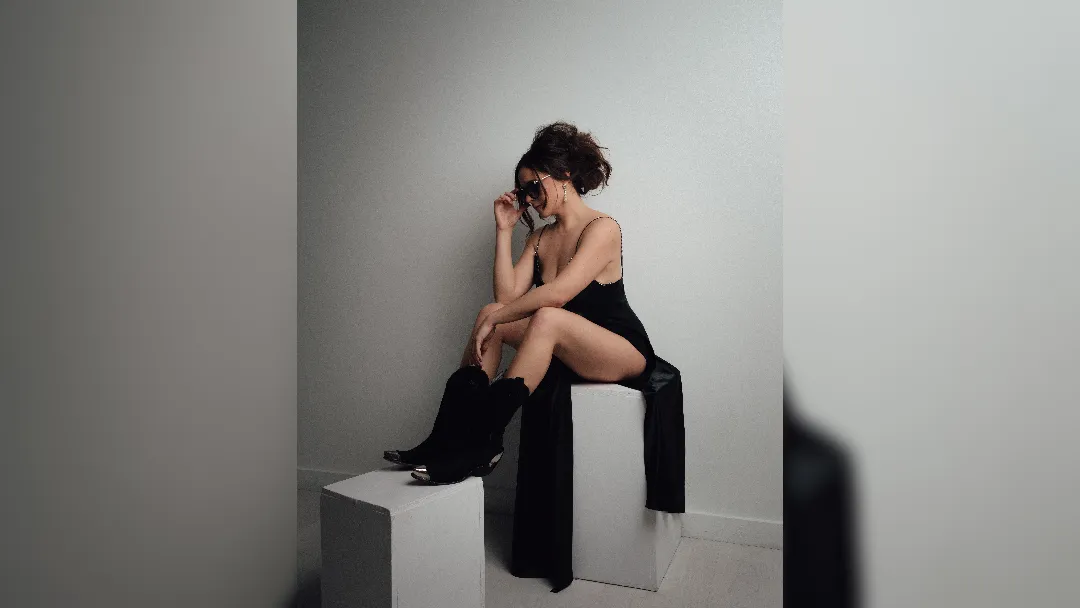 promotional image of Taylor Rae sat on blocks for new single Cologne. image courtesy Barbara FG