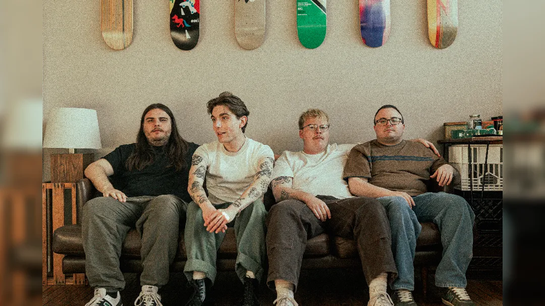 promotional image of Arm's Length sat on a couch. image courtesy Tessa Smith