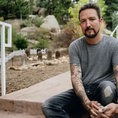 image of Frank Turner sat on stone steps - image courtesy Shannon Shumaker
