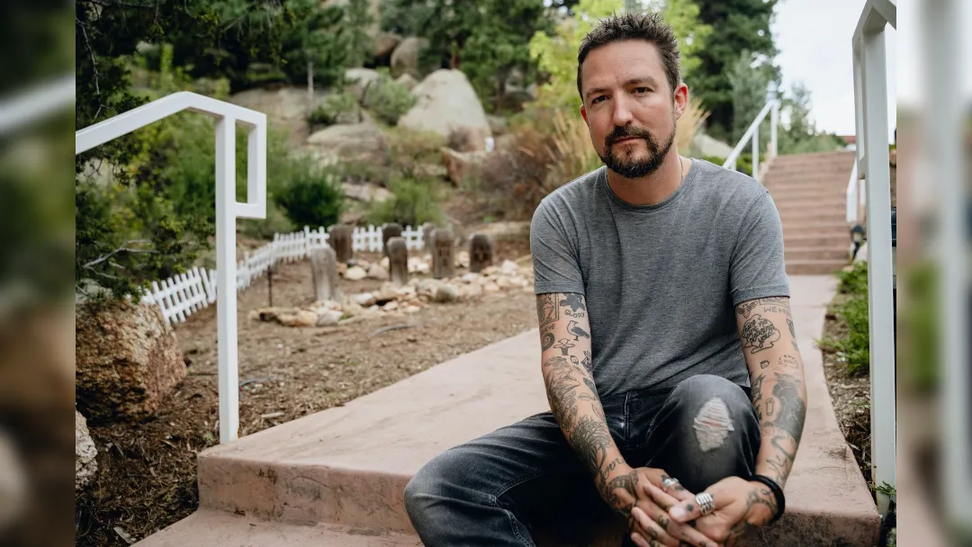 image of Frank Turner sat on stone steps - image courtesy Shannon Shumaker