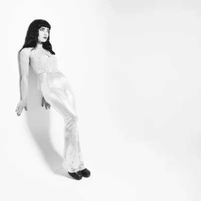 promotional image of Freya Beer leaning against a white background. image courtesy Garry Jones
