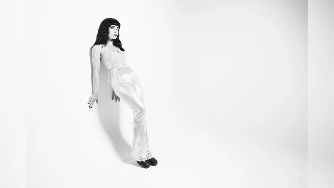 promotional image of Freya Beer leaning against a white background. image courtesy Garry Jones