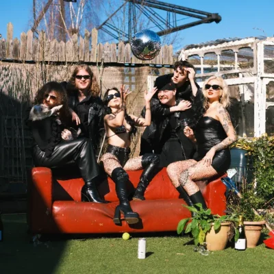 promotional image of Jools sat on a couch in a garden. image courtesy Matt Chapman