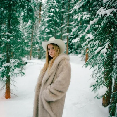 Ingrid Andress standing in a snowy forest