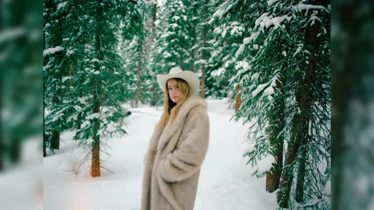 Ingrid Andress standing in a snowy forest