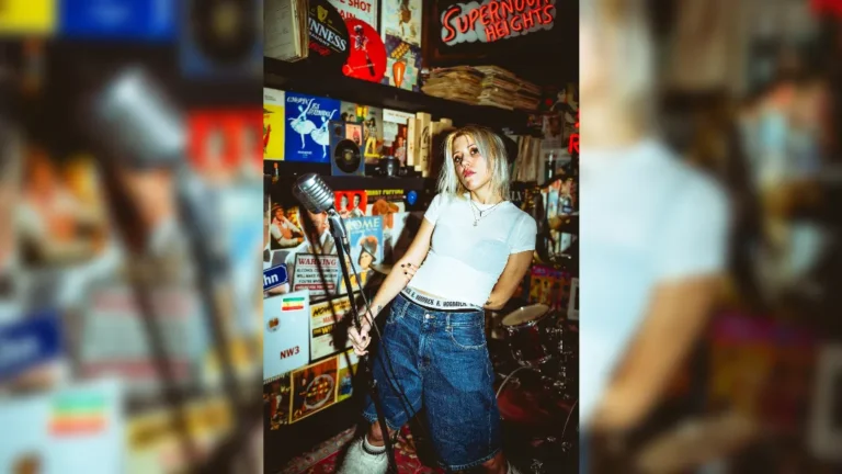 image of Kate Klein stood with a microphone and drum kit
