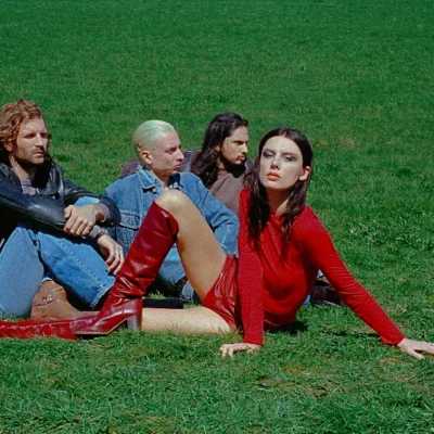 image of Wolf Alice sat on grass. image courtesy Rachel Fleminger Hudson