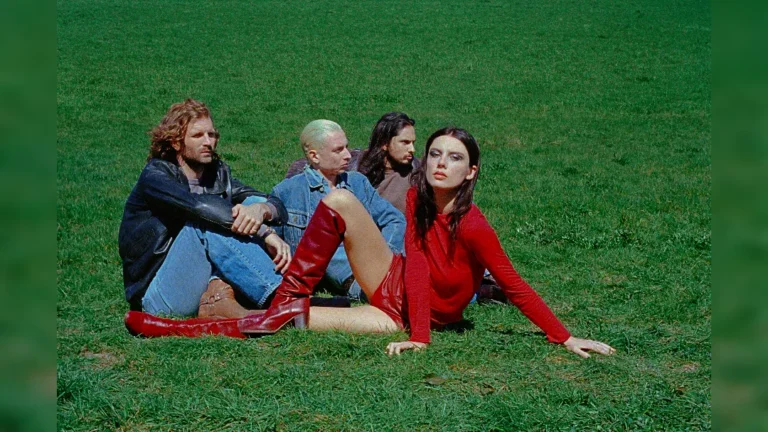 image of Wolf Alice sat on grass. image courtesy Rachel Fleminger Hudson