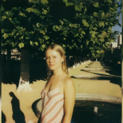 image of Alice Phoebe Lous stood next to trees - image courtesy Caroline Bertolini
